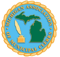 A round blue and gold emblem featuring green silhouettes of Michigan's Upper and Lower Peninsulas, a gold quill and inkwell, and the text "Michigan Association of Municipal Clerks" around the border.