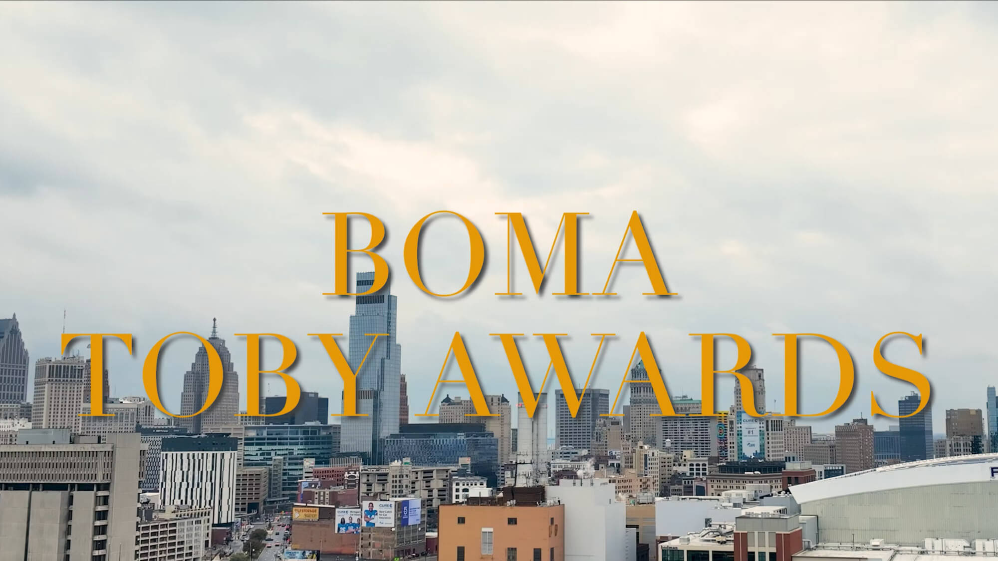 A cloudy city skyline with large yellow text in the center reading "BOMA TOBY AWARDS.