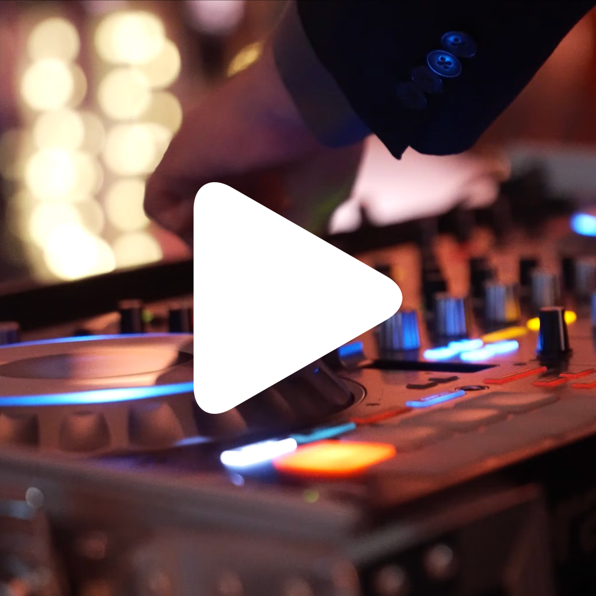 A close-up of a DJ's hand adjusting controls on a mixing console, with colorful lights on the equipment and blurred lights in the background. A large white play button is overlaid on the image.